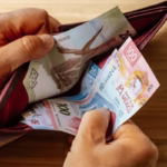 hand-takes-money-out-wallet-600nw-2231317945